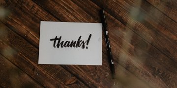 thank you card on table next to black pen