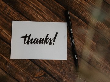 thank you card on table next to black pen